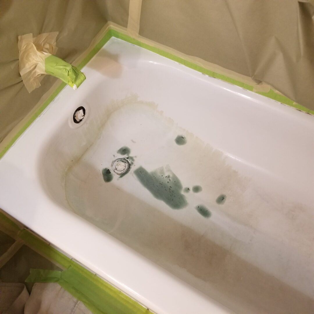 Damaged bathtub with surface staining and wear before repair and refinishing work in Michigan